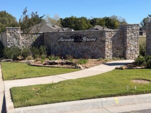 Stone entrance monument sign at Rowan Grove Bixby in Bixby, Oklahoma