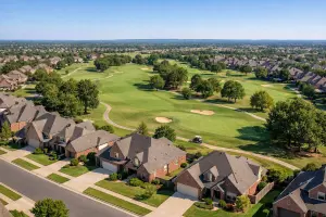 Aerial-style view of Battle Creek Broken Arrow OK golf community with fairways and brick homes surrounding the course